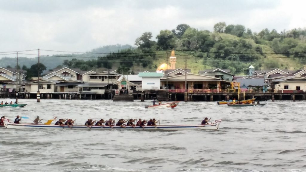Boat race on the river with Kampung Ayer in the background