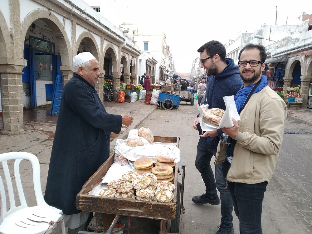 buying bread from a street trader early in the morning