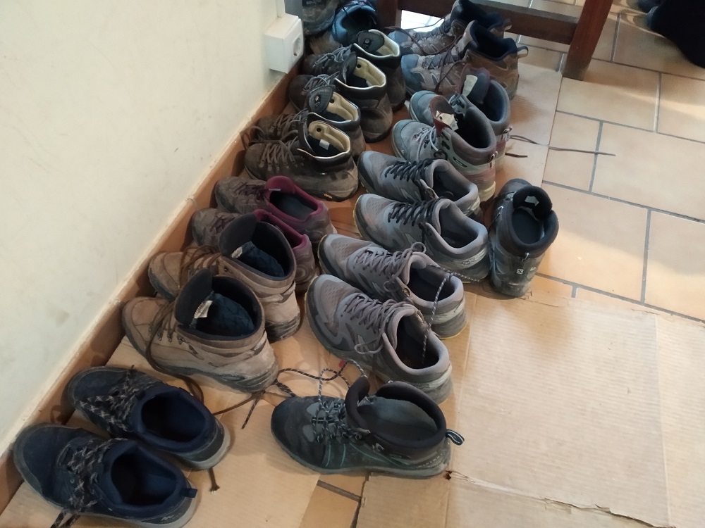 walking boots lined up outside a hostel
